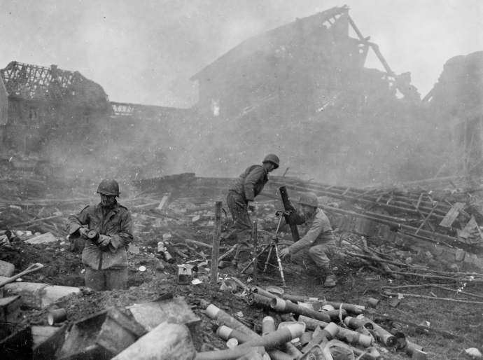 On of the 22nd Infantry's 81mm mortar crews firing in support of the rifle companies holding off a German counter-attack at Grosshau on December 1, 1944.